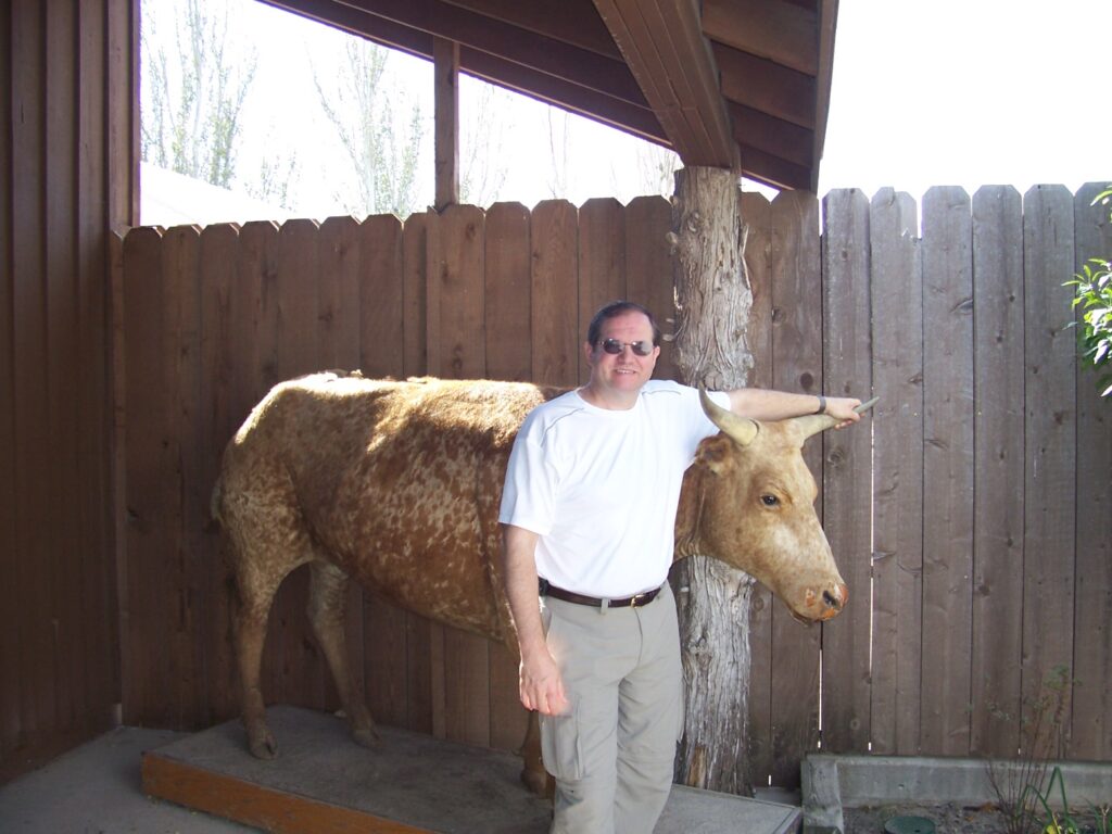 Rob standing by a steer